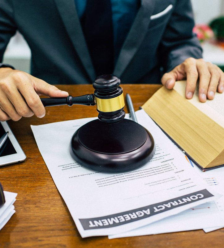 Lawyer preparing legal documents at desk with gavel